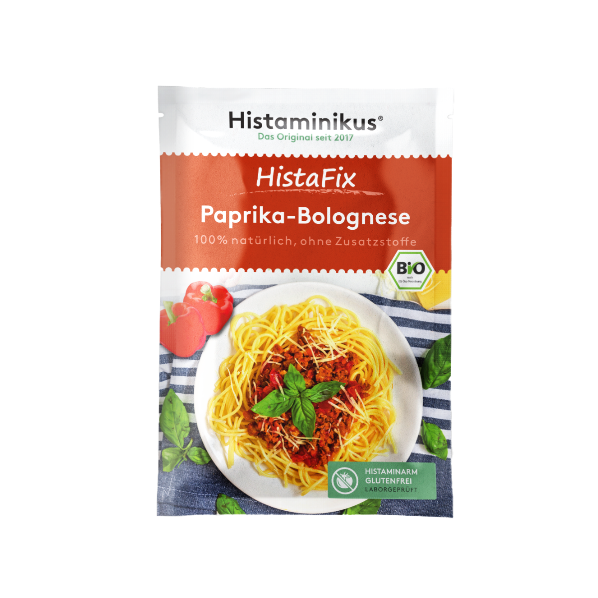 Ein einzelner HistaFix-Beutel „Paprika-Bolognese“ von Histaminikus mit rotem Verpackungsdesign, Teller Spaghetti mit Paprika-Hackfleischsoße, Basilikumblättern und Bio-Siegel, darunter grünes Label „histaminarm, glutenfrei, laborgeprüft“.