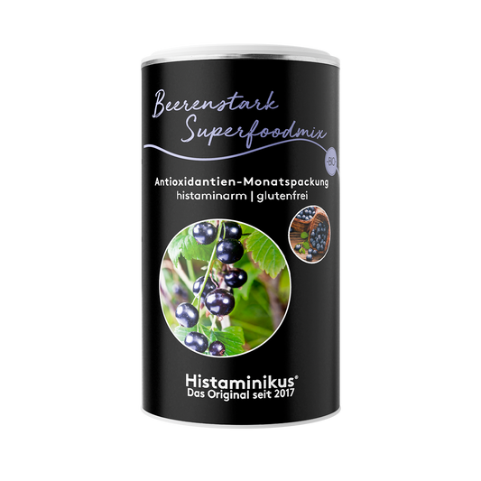 Produktbild des Beerenstark Superfoodmix von Histaminikus in schwarzer Dose mit Aufschrift „Antioxidantien-Monatspackung, histaminarm, glutenfrei“ und Detailfoto von schwarzen Johannisbeeren.