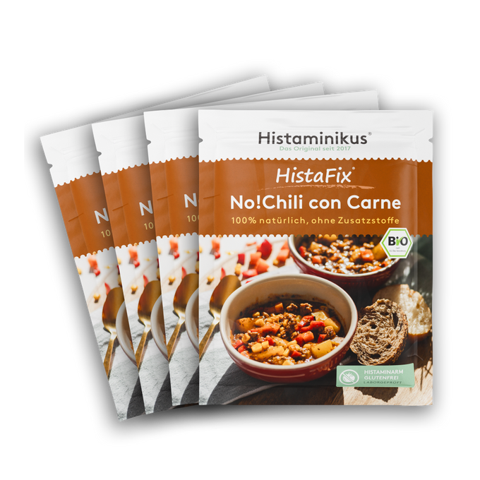 Vier nebeneinander gelegte HistaFix-Beutel „No!Chili con Carne“ von Histaminikus, mit einer Schale würzigem veganem Chili auf der Vorderseite, warm-braunes Verpackungsdesign mit Bio-Siegel und dem Hinweis „histaminarm, glutenfrei, laborgeprüft“.