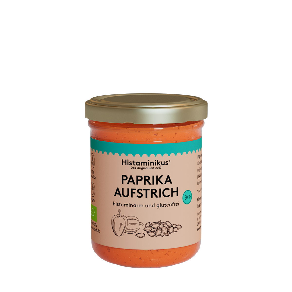Glas mit orangem Inhalt und goldenem Deckel. Etikett mit der Aufschrift: Paprikaaufstrich. Der Inhalt wird als histaminarm und glutenfrei bezeichnet. Außerdem sind auf dem Etikett zwei Paprika und Kürbiskerne zu sehen. Das Bio-Siegel ist rechts in einem kräftigen Türkis aufgedruckt.