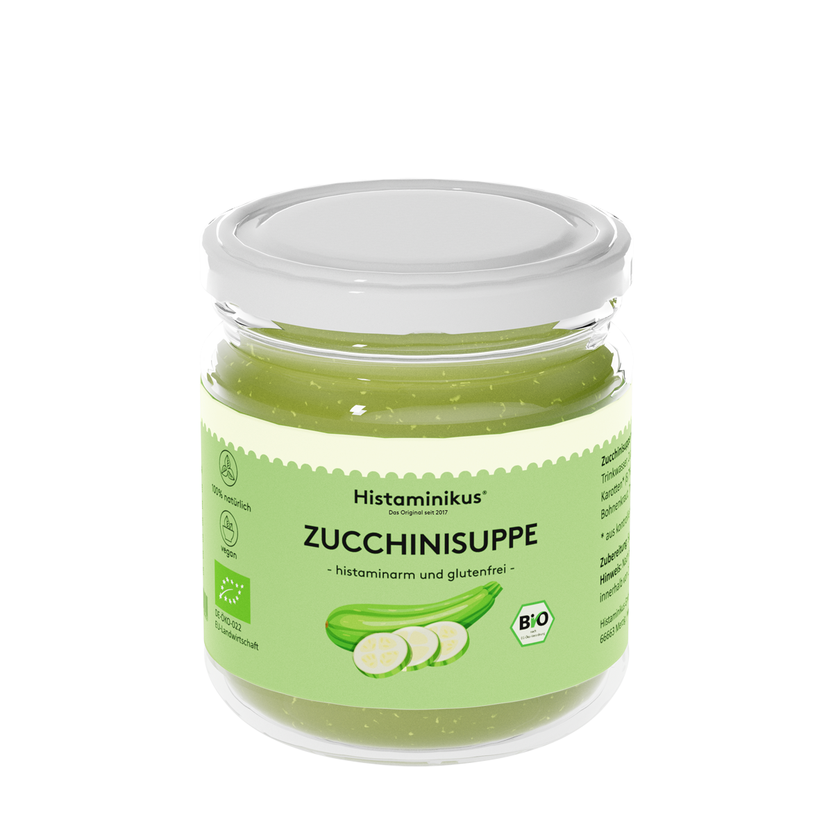 Ein Glas mit weißem Deckel, gefüllt mit hellgrüner Zucchinisuppe. Auf dem Etikett steht „Histaminikus – Das Original seit 2017“, darunter in Schwarz „ZUCCHINISUPPE – histaminarm und glutenfrei“. Abgebildet ist eine grüne Zucchini mit drei Zucchinischeiben. Symbole weisen auf 100 % natürliche Zutaten, Veganität und EU-Bio-Zertifizierung hin.
