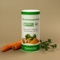 Dose der V5 Universalwürze von Histaminikus auf beigem Untergrund, daneben zwei Karotten und ein Zweig Thymian. Auf der Dose abgebildet sind Petersilie, Knollensellerie, Kurkuma und weitere Gewürze. Aufdrucke: „histaminarm“, „glutenfrei“, „FODMAP-bewusst“, „ohne Hefe“ und „Bio“.