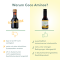 Vergleichsgrafik mit Titel „Warum Coco Aminos?“.
Links: Flasche mit Aufschrift „Sojasoße“, Daumen runter, drei Nachteile aufgelistet.
Rechts: Flasche „Coco Aminos“, Daumen hoch, drei Vorteile: histaminarme Zutaten, laborgeprüft, in Deutschland hergestellt.