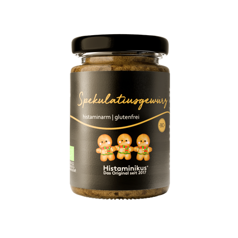 Gläschen mit schwarzem Deckel und Etikett vom Spekulatiusgewürz mit drei lustigen Keksen mit Gesichtern 