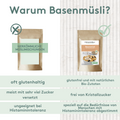 Grafik mit dem Titel „Warum Basenmüsli?“ Zwei Produktabbildungen nebeneinander: links eine neutrale braune Verpackung mit dem Text „Herkömmliche Müslimischungen“ und einem durchgestrichenen Kreis darüber; rechts die Verpackung des Histaminikus Basenmüslis mit Häkchen. Darunter drei Vergleichszeilen:
– Links: „oft glutenhaltig“, „meist mit sehr viel Zucker versetzt“, „ungeeignet bei Histaminintoleranz“.
– Rechts: „glutenfrei und mit natürlichen Bio-Zutaten“, „frei von Kristallzucker“, „speziell auf die Bedür