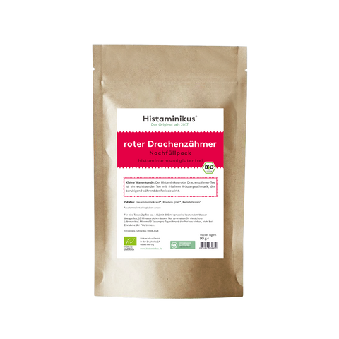Braune Nachfüllpackung mit weiß-rotem Etikett. Produktname „roter Drachenzähmer – Nachfüllpack“ in kräftigem Rot, darunter „histaminarm und glutenfrei“. Ein kurzer Infotext beschreibt den Tee als wohltuend und beruhigend während der Periode. Aufgelistet sind die Zutaten: Frauenmantelkraut, grüner Rooibos, Kamillenblüten. BIO-Siegel und Laborgeprüft-Symbol am unteren Rand des Etiketts.