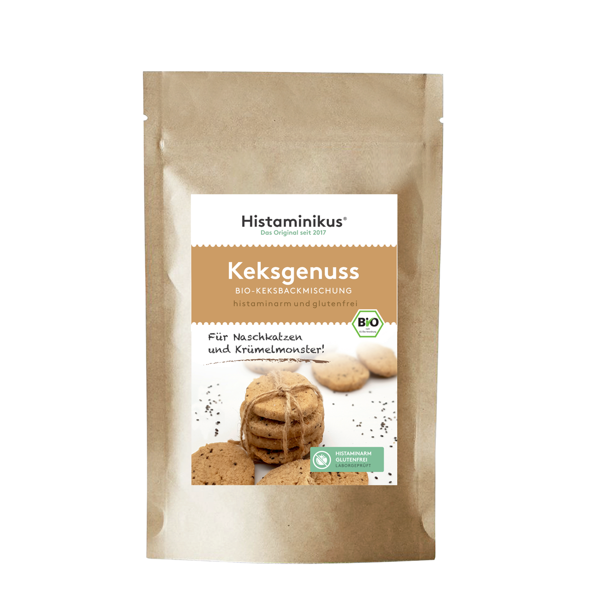 Braune Papierverpackung mit weißem Etikett. Aufschrift „Histaminikus – Keksgenuss – Bio-Keksbackmischung“, darunter „histaminarm und glutenfrei“. In der Mitte ein Foto mit mehreren Keksen, ein paar lose, andere zu einem Stapel gebunden. Daneben der Text „Für Naschkatzen und Krümelmonster!“, unten ein grünes Label mit dem Hinweis „histaminarm, glutenfrei, laborgeprüft“.