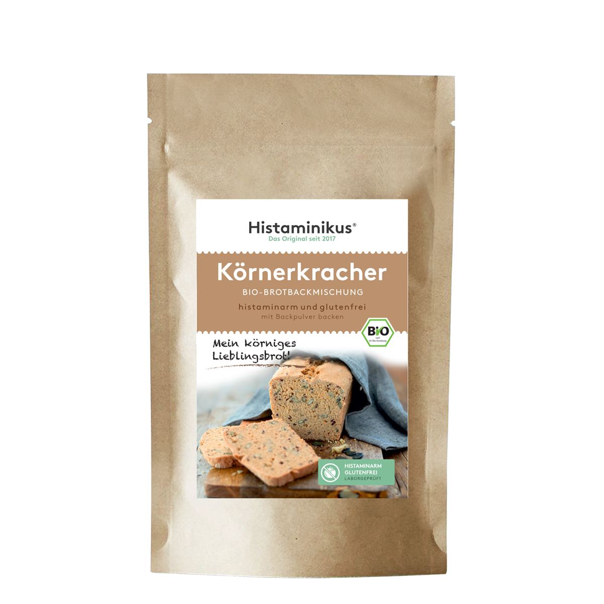Beige Papiertüte mit Etikett. Produktname „Körnerkracher“ auf braunem Hintergrund. Darunter ein Foto eines angeschnittenen Körnerbrots mit Brotscheiben. Mit Bio-Siegel und grünem „Histaminarm – Glutenfrei – Laborgeprüft“-Label.