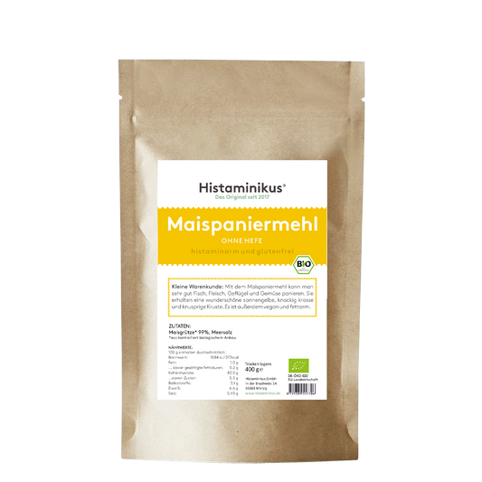 Produktfoto der braunen Standbodenverpackung von Histaminikus. Vorderseite mit weißem Etikett und gelbem Akzent. Oben steht „Maispaniermehl – ohne Hefe – histaminarm und glutenfrei“. Darunter Text zur Anwendung: für Fleisch, Fisch, Geflügel und Gemüse, ergibt eine knusprige Kruste, fettarm und vegan. Im unteren Bereich Nährwerttabelle und Zutatenliste: Maisgrieß (99 %), Meersalz. Verpackungsinhalt: 400 g.