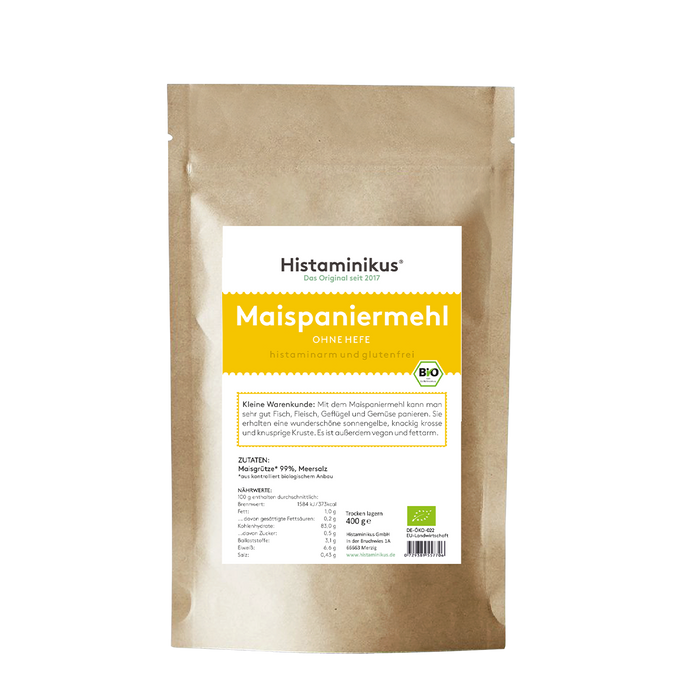 Produktfoto der braunen Standbodenverpackung von Histaminikus. Vorderseite mit weißem Etikett und gelbem Akzent. Oben steht „Maispaniermehl – ohne Hefe – histaminarm und glutenfrei“. Darunter Text zur Anwendung: für Fleisch, Fisch, Geflügel und Gemüse, ergibt eine knusprige Kruste, fettarm und vegan. Im unteren Bereich Nährwerttabelle und Zutatenliste: Maisgrieß (99 %), Meersalz. Verpackungsinhalt: 400 g.