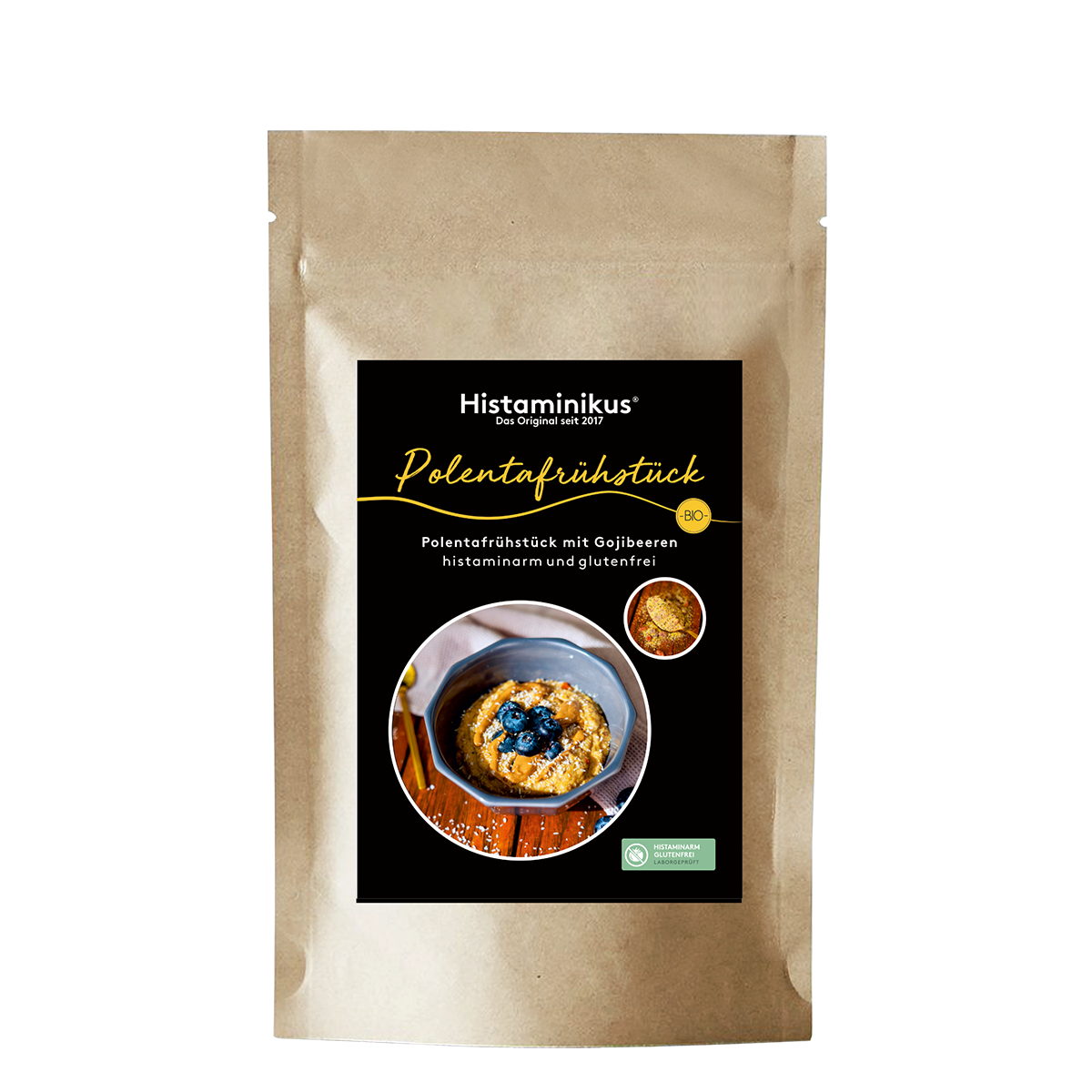Standbeutel aus braunem Kraftpapier mit schwarzem Etikett von Histaminikus. Auf dem Etikett steht „Polentafrühstück“ sowie „Polentafrühstück mit Gojibeeren, histaminarm und glutenfrei“. Abgebildet ist eine Schale mit cremigem Polenta-Frühstück, garniert mit Heidelbeeren. Oben rechts befindet sich ein rundes Detailbild der Mischung, daneben ein gelbes BIO-Siegel. Unten rechts ist ein grünes Siegel mit dem Hinweis auf histaminarm und glutenfrei.