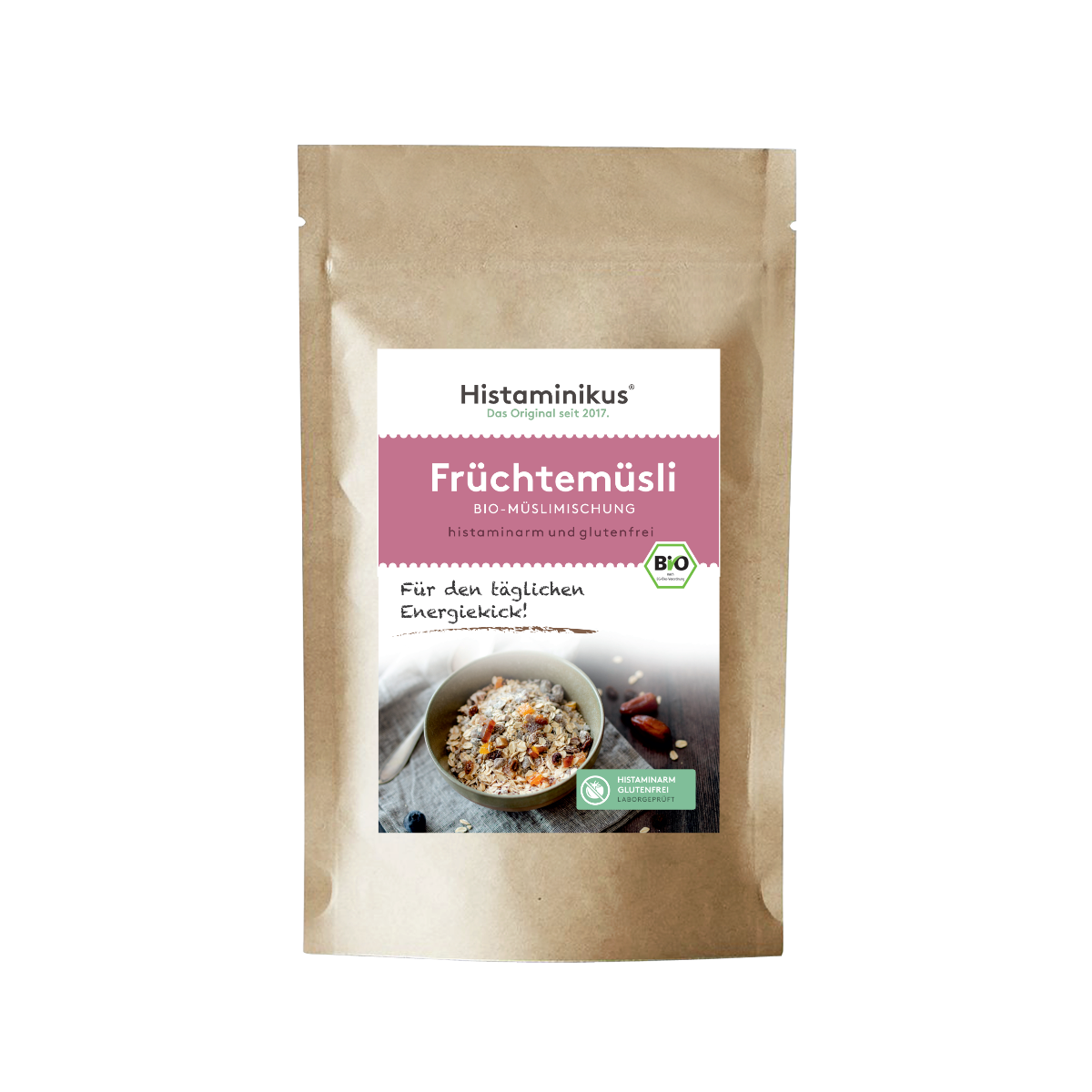 Braune Papierverpackung mit weißem Etikett. Produktname „Früchtemüsli“ in rosa Schrift, darunter „Bio-Müslimischung, histaminarm und glutenfrei“. Foto einer Müslischale mit Löffel und Trockenfrüchten.